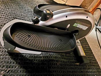 Reviewer photo of the small portable elliptical with black petals on each side 