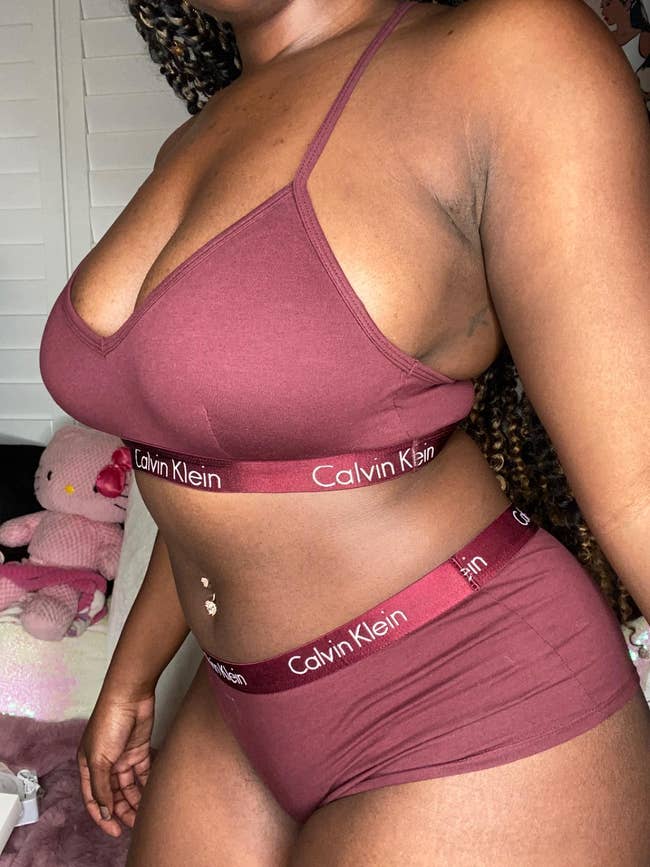 A reviewer wearing a Calvin Klein bralette and matching underwear set