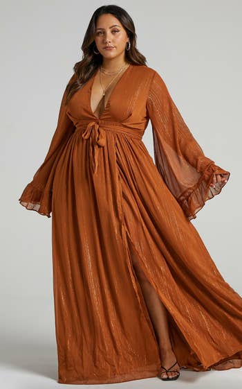 another model in rust orange showing the motion