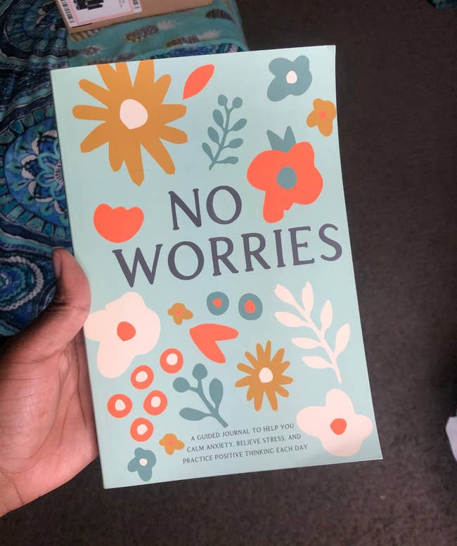 Person holding a diary titled