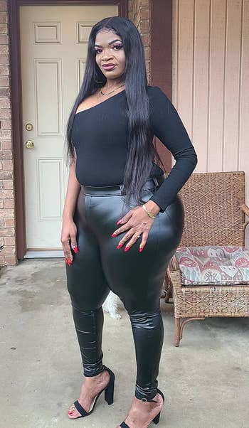 reviewer showing off the front of the black leggings