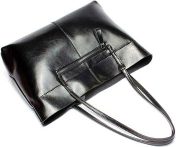 Black leather clutch with a zipper and shoulder strap