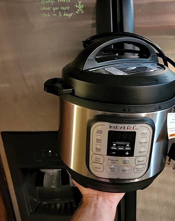 reviewer holding instant pot