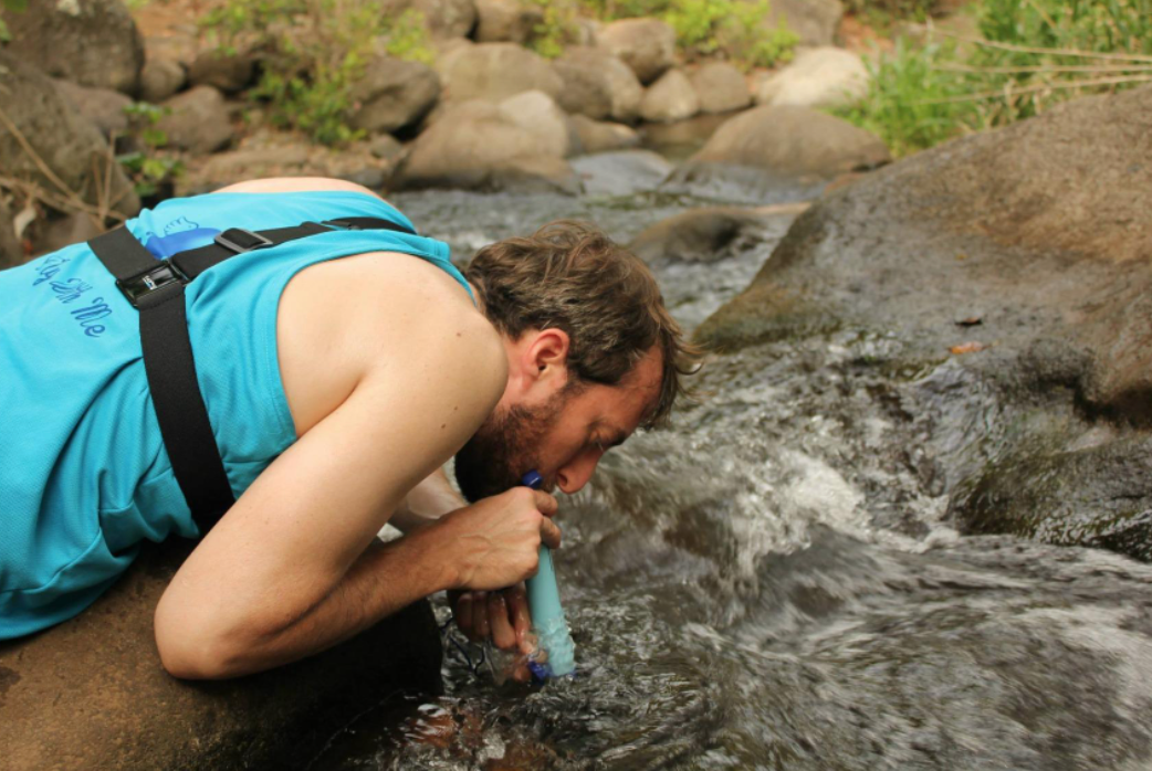 reviewer drinking in a river through the straw 