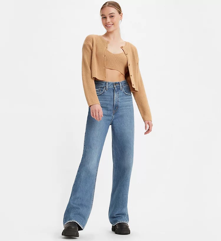 a model posing in long blue high loose jeans
