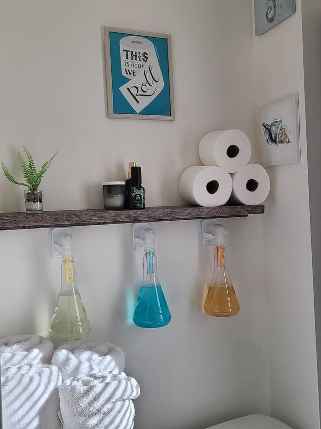 white integrative hooks holding cleaning sprays