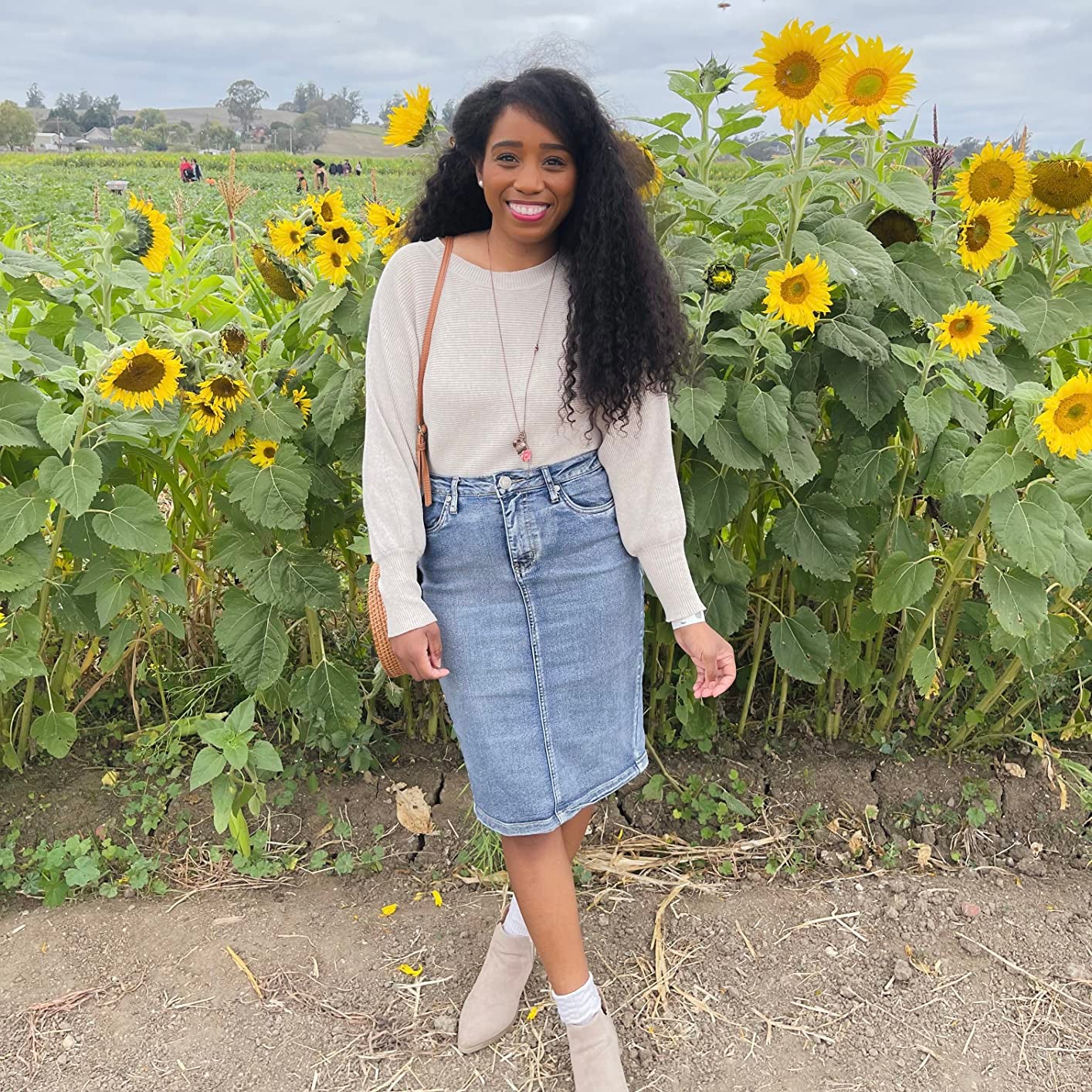 A reviewer posing in the knee-length denim skirt