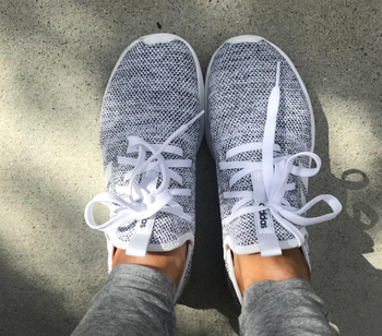 reviewer wearing the sneakers in gray