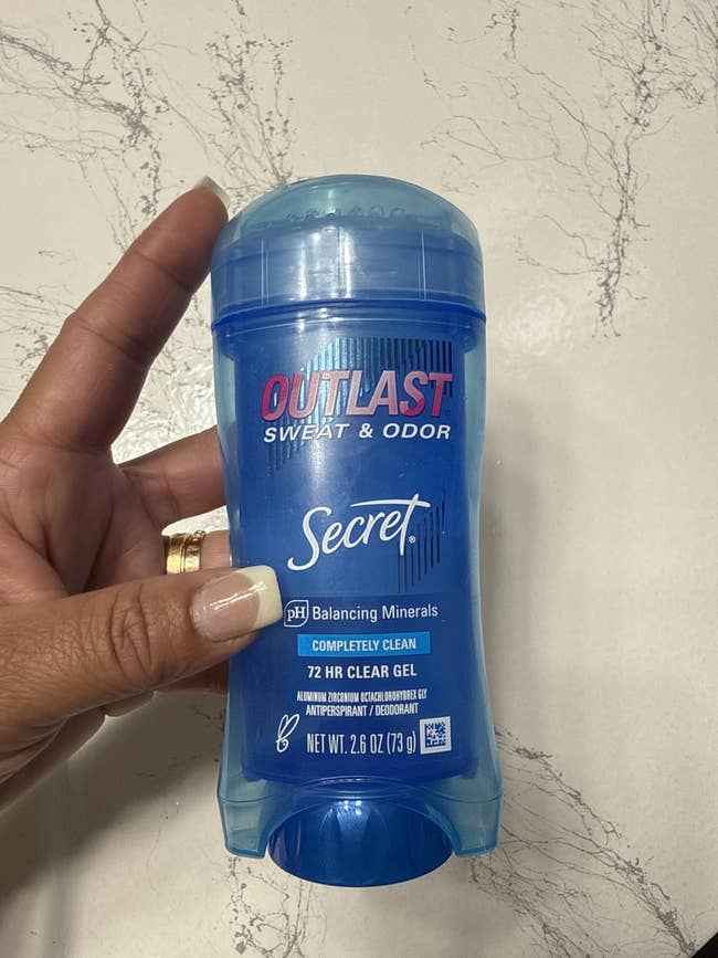 Hand holding Secret Outlast deodorant