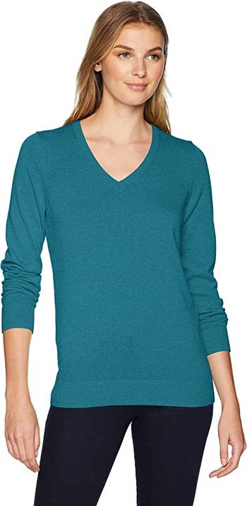 model wearing the v-neck sweater in teal blue