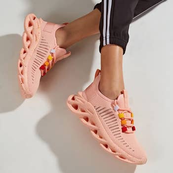 model wearing chunky platform pink sneakers with colorful lace slots