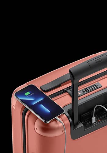 Smartphone charging connected  a sleek suitcase with integrated USB port, showcasing modern   question   convenience