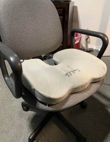 gray pillow on the seat of an office chair 