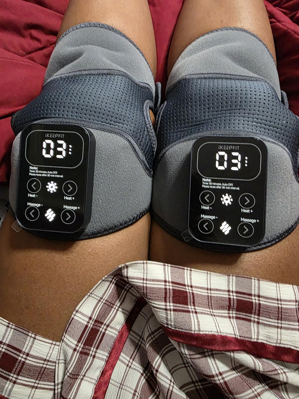 Person utilizing genu  therapy devices with integer  displays and plaid shorts