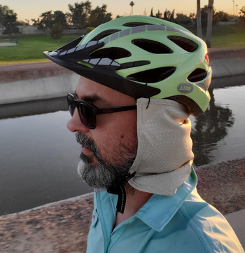 Reviewer with beige neck drape attached to helmet 