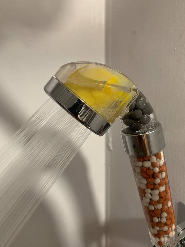 Showerhead with lemon balm inside and beads for water filtration