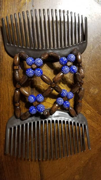 reviewer photo of the opened clip comb in navy blue and brown beads