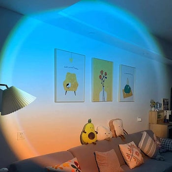 blue and orange sunset light projected onto living room wall