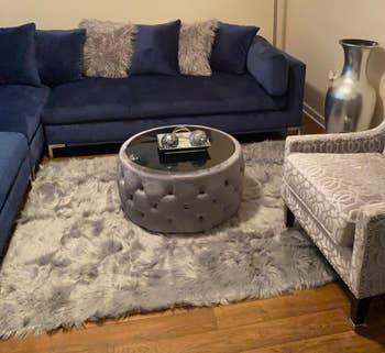 Reviewer image of the gray ottoman coffee table in their living room