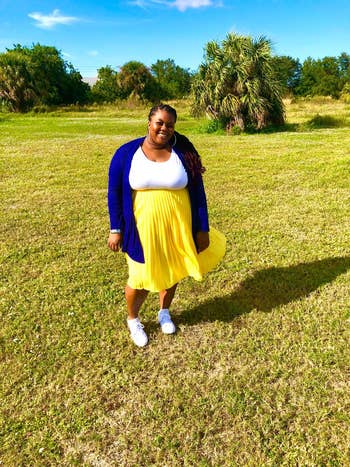 reviewer wearing the skirt in bright yellow
