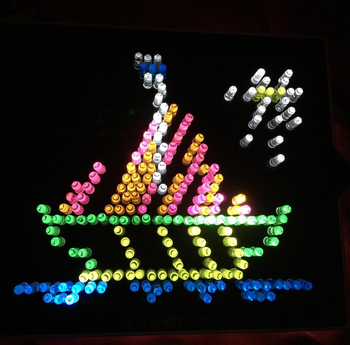 reviewer photo of a completed Lite-Brite template of a boat