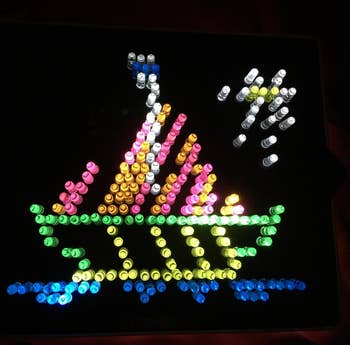 reviewer photo of a completed Lite-Brite template of a boat