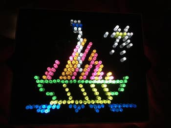 reviewer photo of a completed Lite-Brite template of a boat