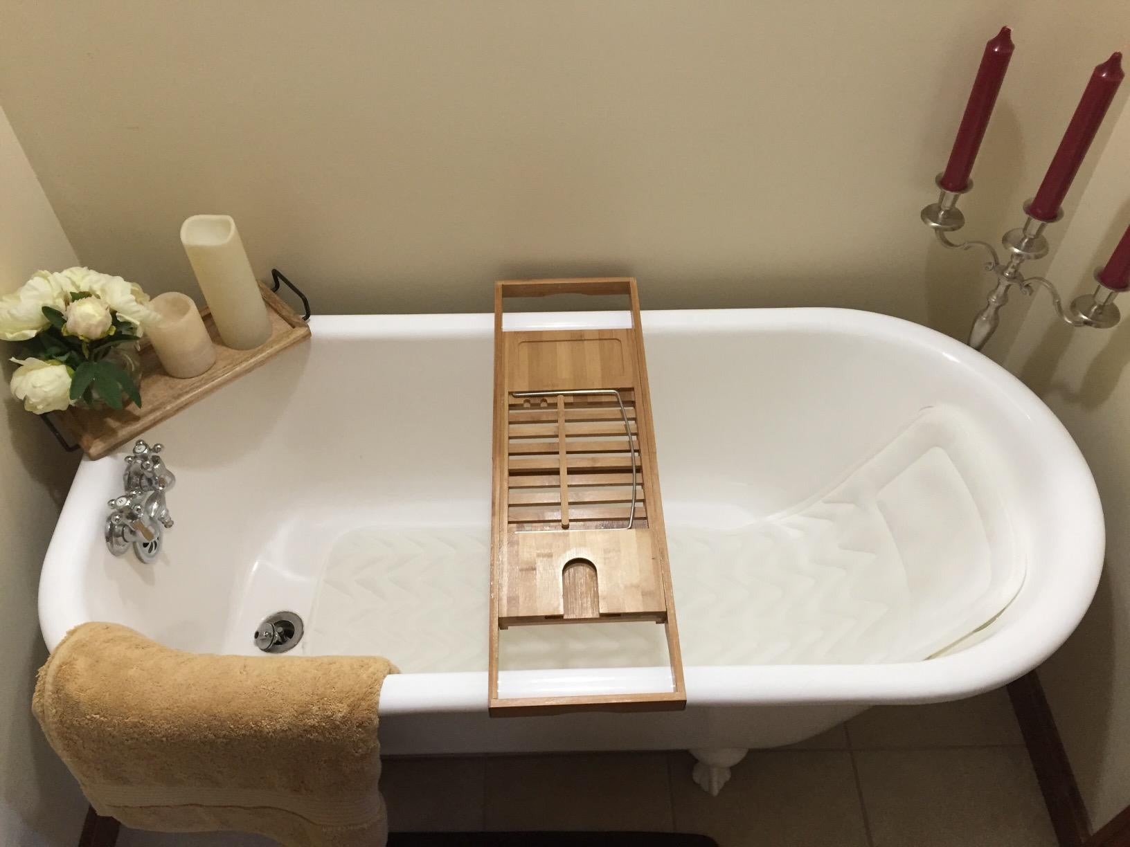 reviewer image of the bath pillow in a tub