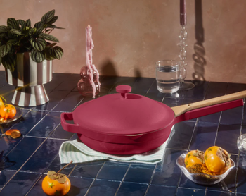 dark pink Always Pan with attachable spoon on blue tile kitchen counter