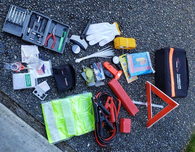 a roadside emergency kit all laid out with various tools for the car