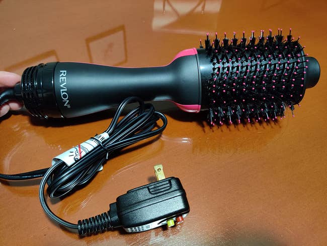 Reviewer's blow dryer brush on brown background
