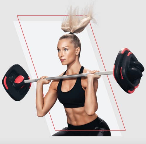 woman lifting barbell with weight plates on the end