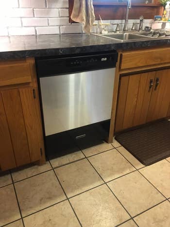 a reviewers dishwasher with stainless steel contact paper over it
