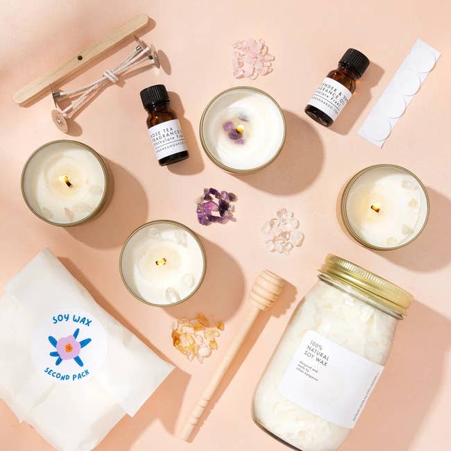 the whole candle kit with it's included items and four finished candles lit