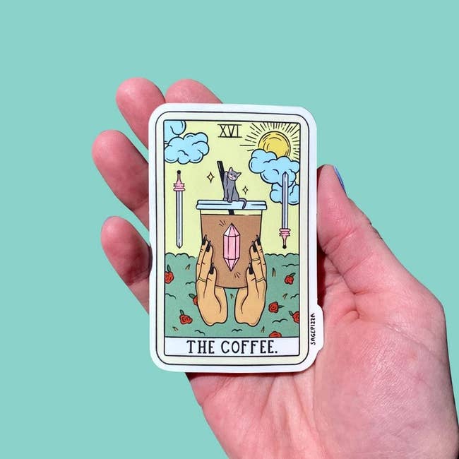 a tarot inspired coffee sticker with two hands holding an iced coffee