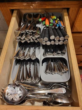 Organized drawer containing assorted cutlery and utensils