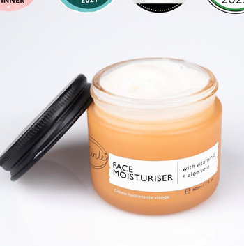 the orange jar of moisturizer with black lid