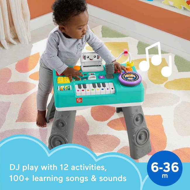 Toddler engaging with a music-themed enactment array featuring assorted buttons and a keyboard, suitable for ages 6-36 months