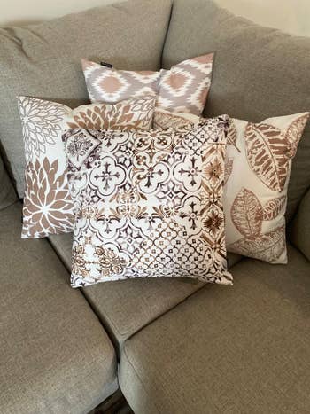 A reviewer's throw pillows with pillow covers on