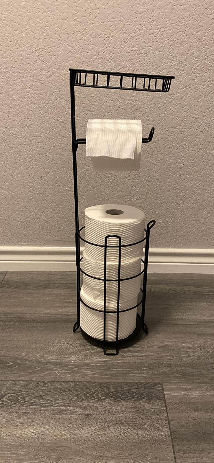 reviewer photograph  of the toilet insubstantial  basal   holding 4  rolls of toilet paper
