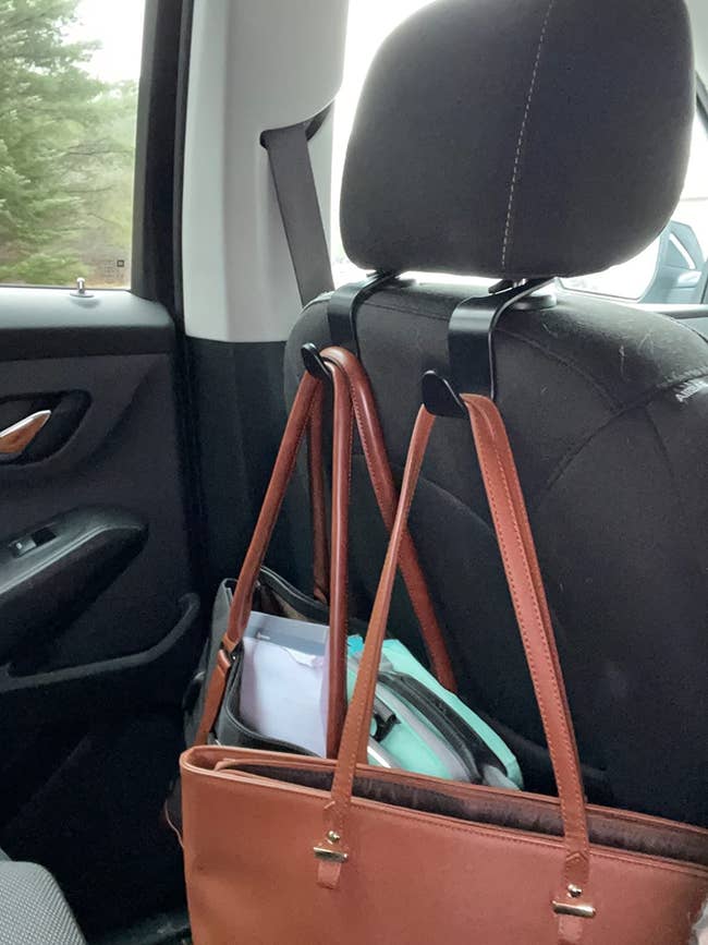 reviewer image of two bags hanging from car headrests