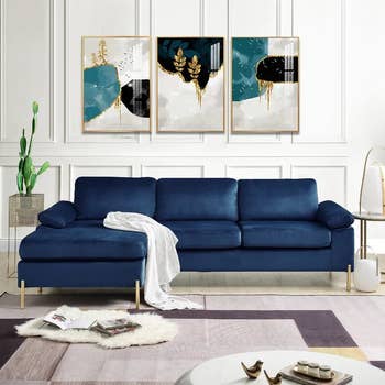 the blue velvet sofa in a living room