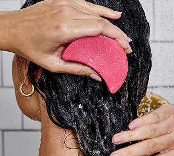 model utilizing shampoo bar