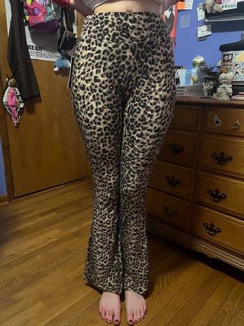 reviewer wearing leopard print flare leggings