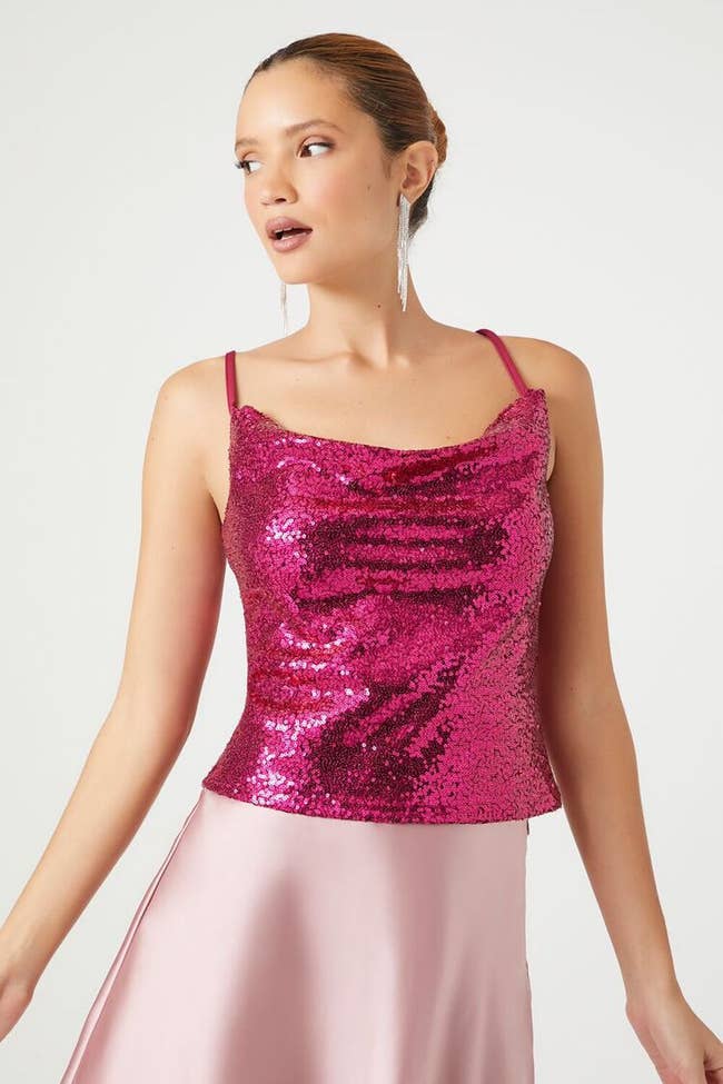 model posing in the pink cowl neck tank