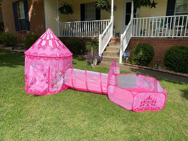 a reviewer's pop up pink tent, tunnel, and ball pit