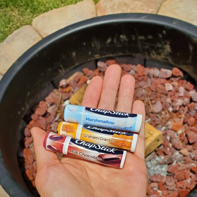 image of the three chapsticks in the palm of a reviewer's hand