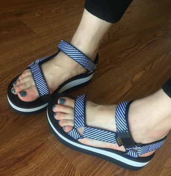 Reviewer wearing blue Teva sandals