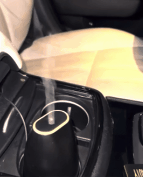 gif of another reviewer's humidifier in the car cupholder emitting steam