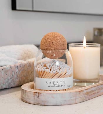 matches in glass container with round cork lid